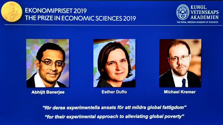 The portraits of Abhijit Banerjee, Esther Duflo, and Michael Kreme, who have been announced the Nobel Prize in Economic Sciences 2019 winners, are seen at a news conference at the Royal Swedish Academy of Sciences in Stockholm, Sweden, October